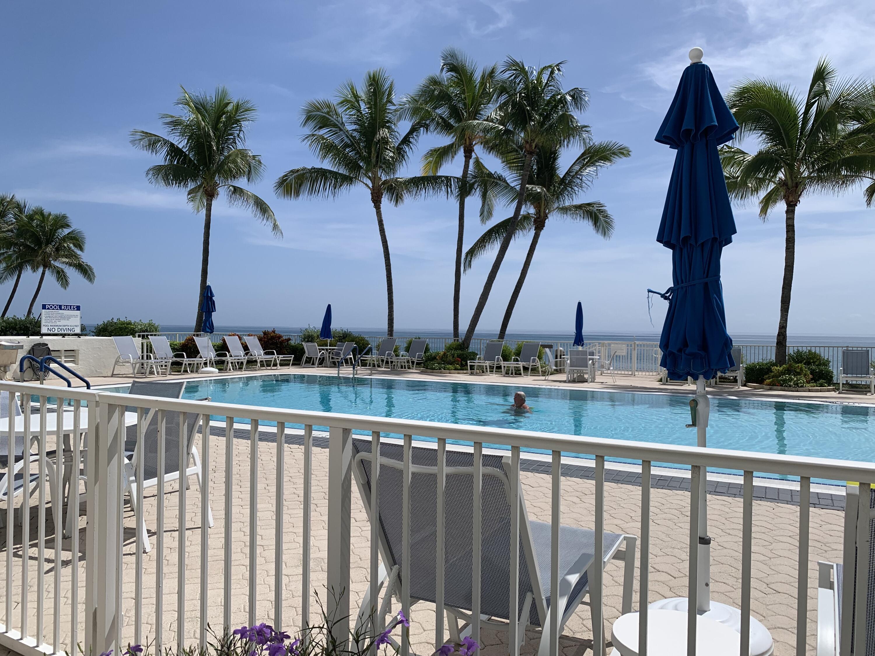 3101 South Ocean Boulevard, Unit 712 Highland Beach, FL 33487 - Photo 21 of 25 a view of balcony with a potted plant and palm trees