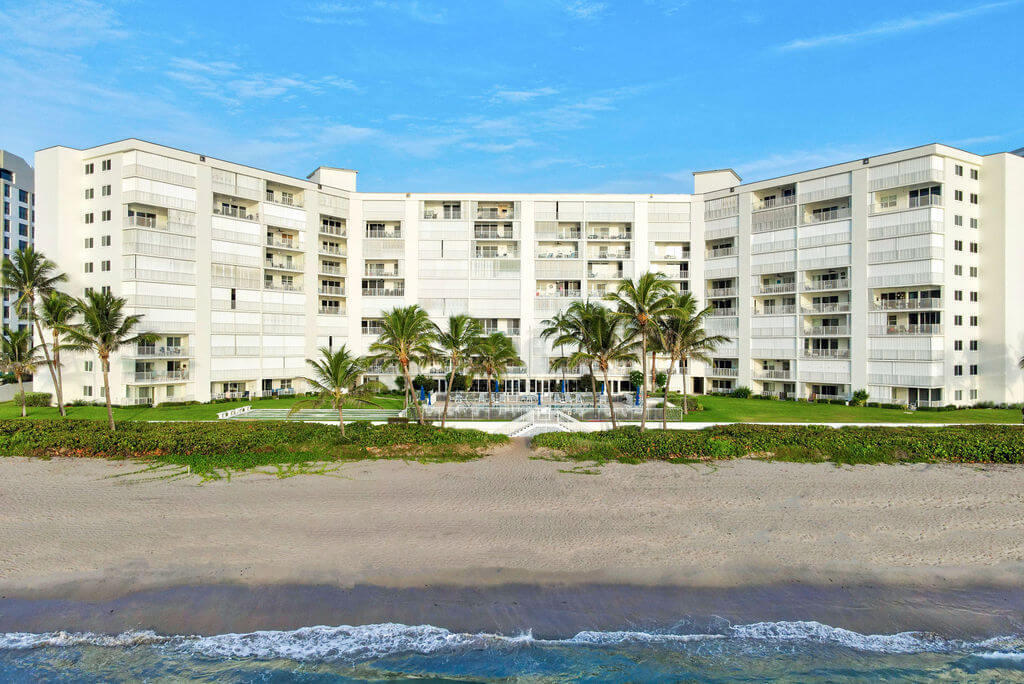 3101 South Ocean Boulevard, Unit 712 Highland Beach, FL 33487 - Photo 23 of 25 a front view of a building with a garden and trees