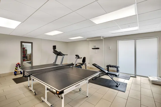 a room with gym equipment and view of living room