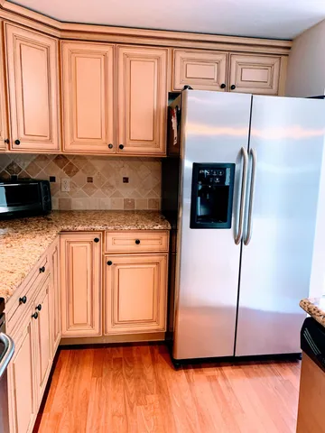 a kitchen with stainless steel appliances a refrigerator and a stove