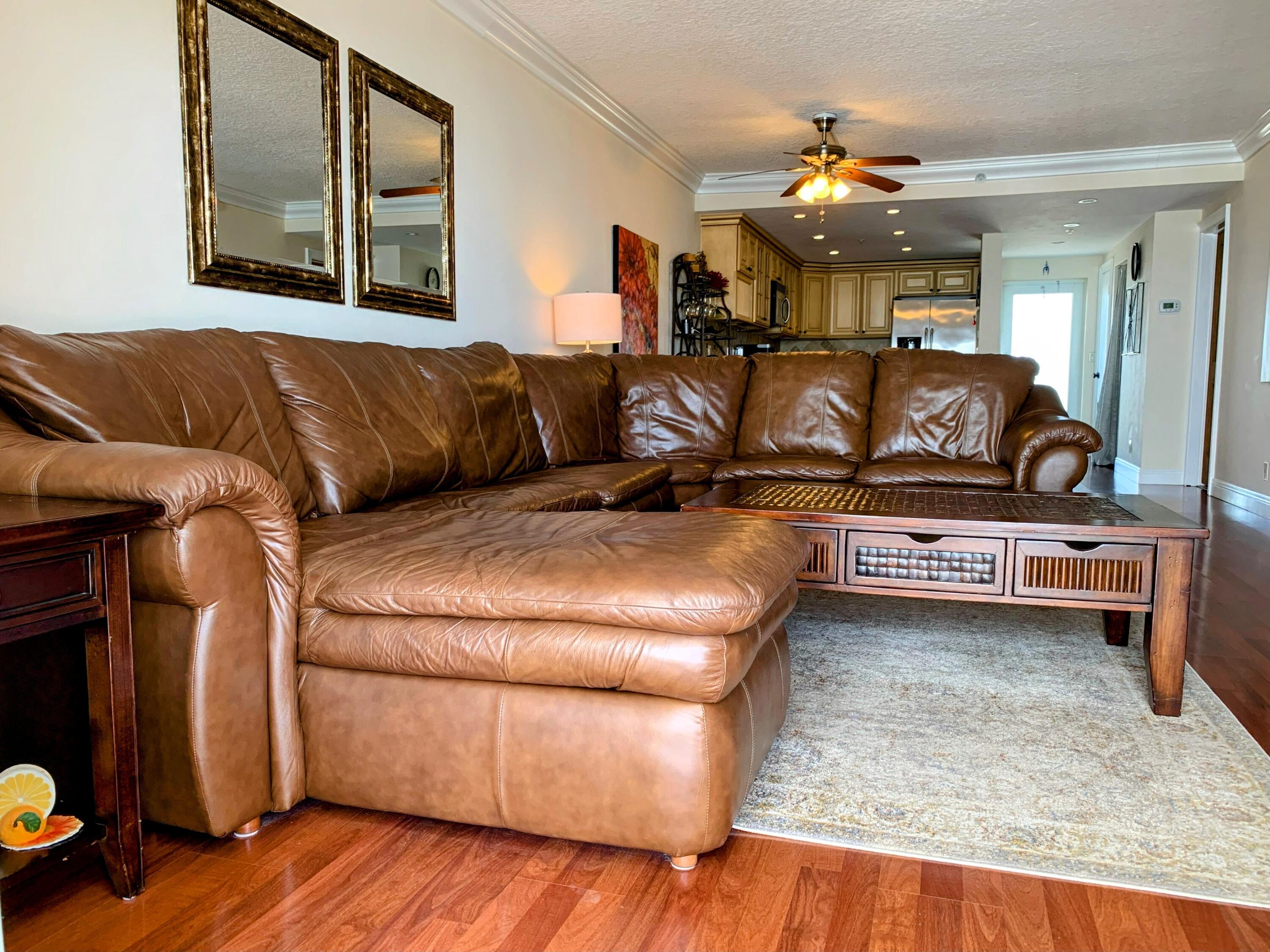3101 South Ocean Boulevard, Unit 712 Highland Beach, FL 33487 - Photo 7 of 25 a living room with furniture and wooden floor
