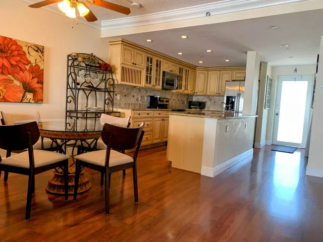 a view of a dining room with furniture and wooden floor