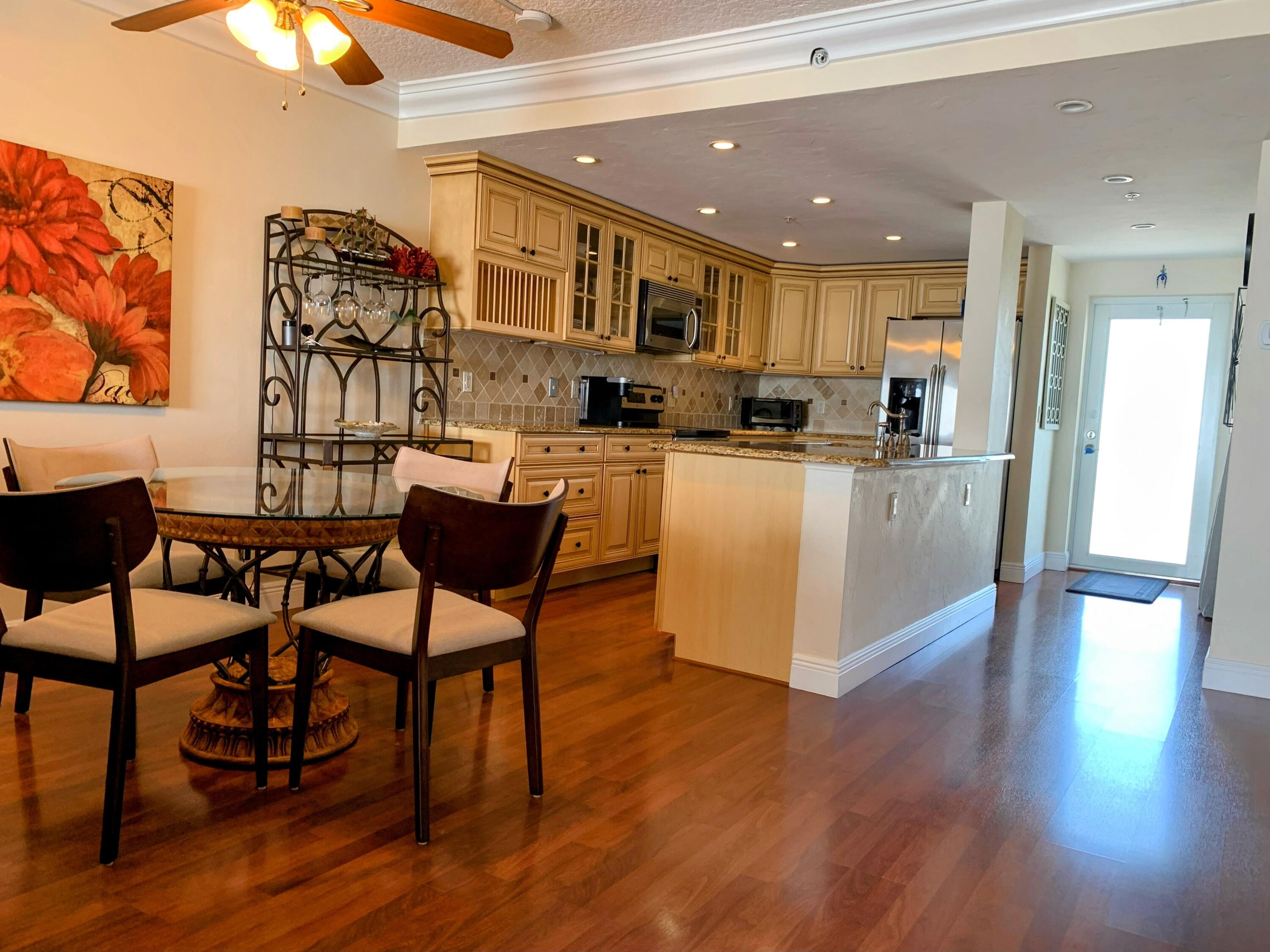 3101 South Ocean Boulevard, Unit 712 Highland Beach, FL 33487 - Photo 10 of 25 a view of a dining room with furniture and wooden floor
