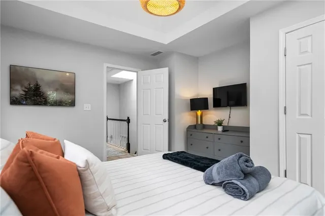 a bedroom with a bed and dresser