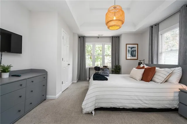 a bedroom with a bed and a chandelier