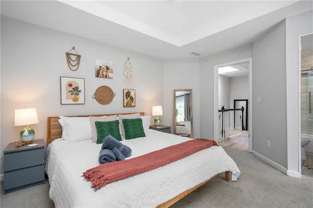 a bedroom with a bed and painting on the wall