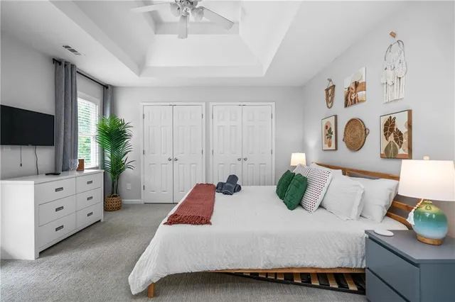 a bedroom with a bed and a flat screen television