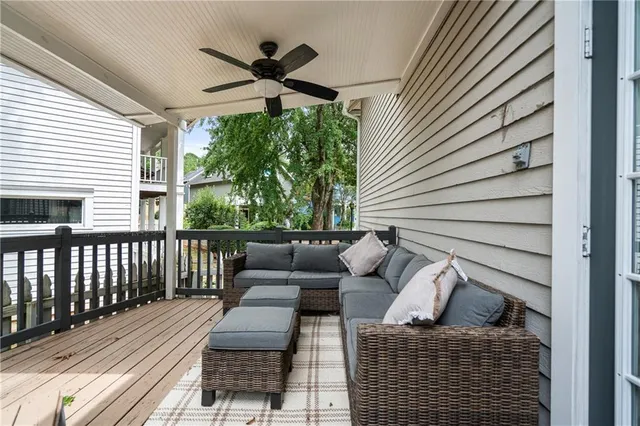 a living room with couch and a ceiling fan