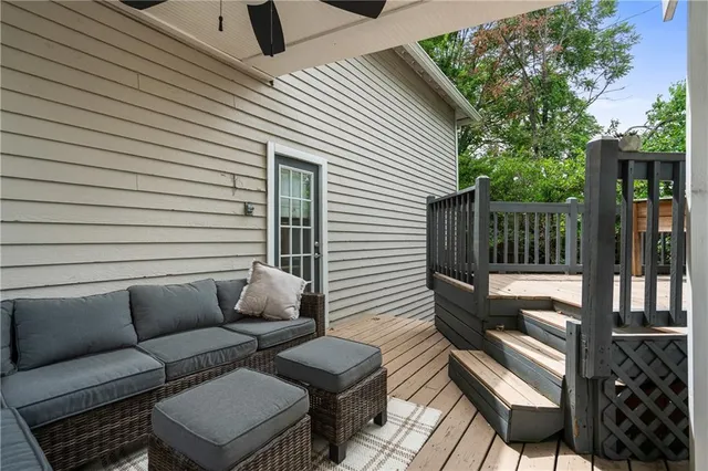 a roof deck with couch and chairs