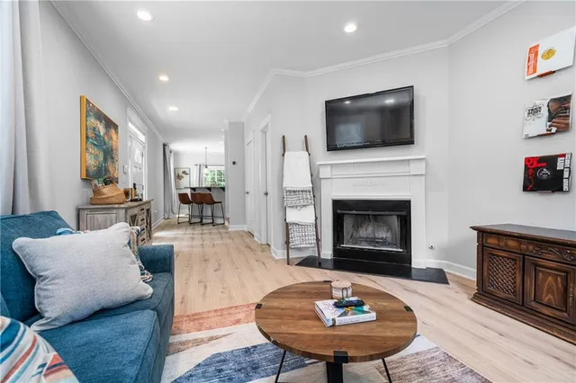 a living room with furniture a flat screen tv and a fireplace