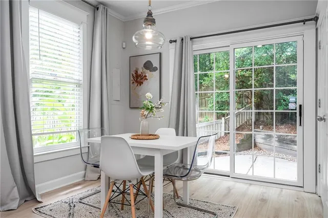 a view of a dining room with furniture large windows and wooden floor