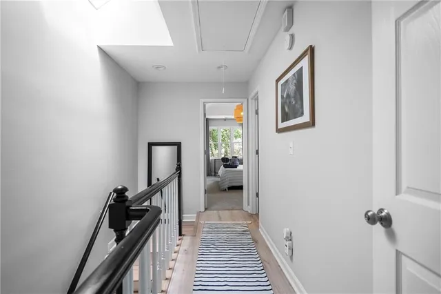 a view of a hallway with closet and a window