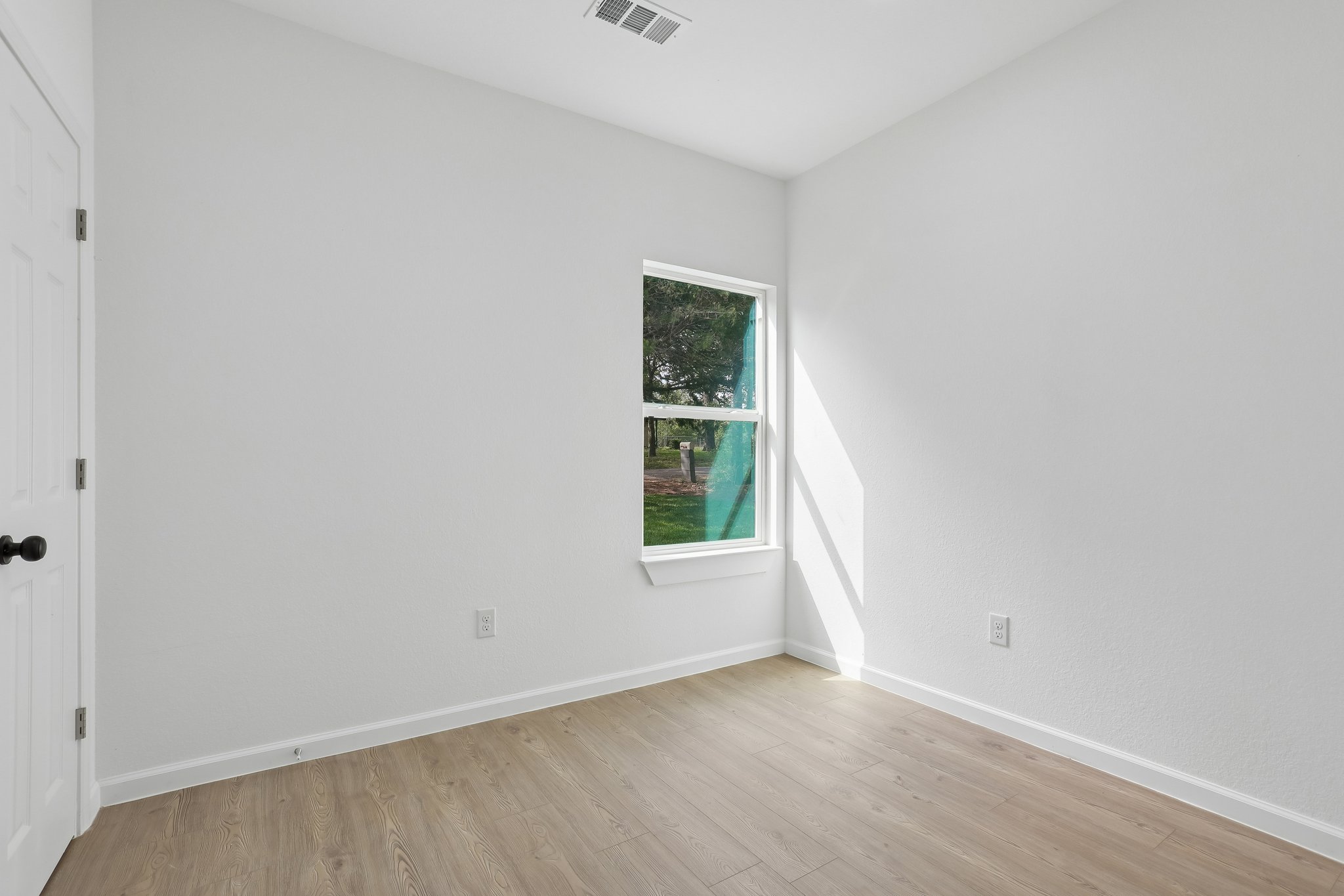 210 Flint Ridge Street Bastrop, TX 78602 - Photo 24 of 40 a view of an empty room with wooden floor and a window