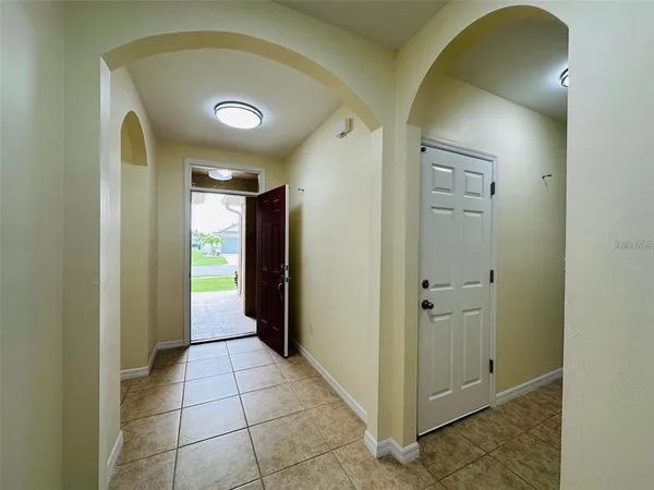 a view of a hallway with wooden shelves