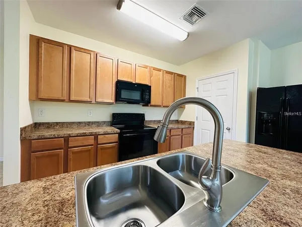 a kitchen with a stove a sink and a refrigerator