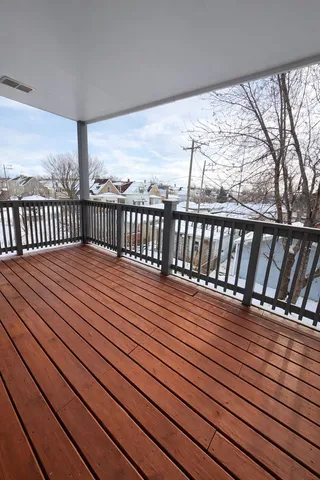 a balcony with wooden floor