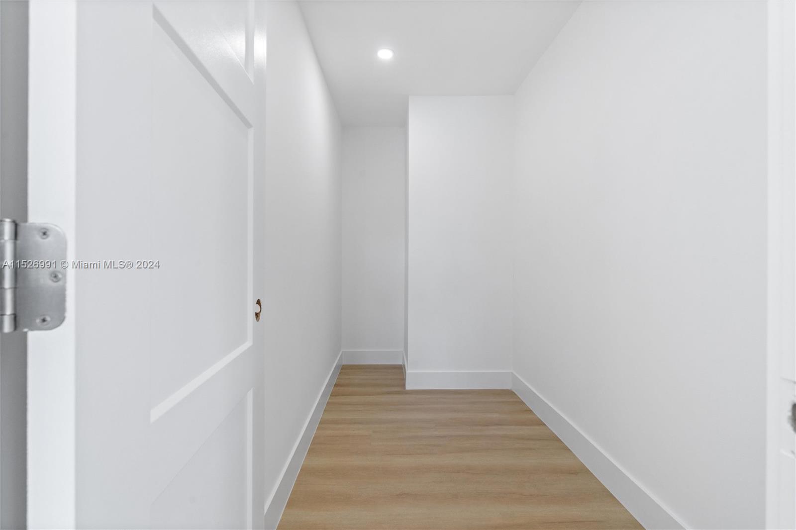 1135 Avocet Road Delray Beach, FL 33444 - Photo 8 of 17 a view of a hallway with wooden floor