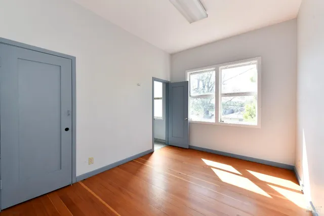 a view of a room with wooden floor and staircase