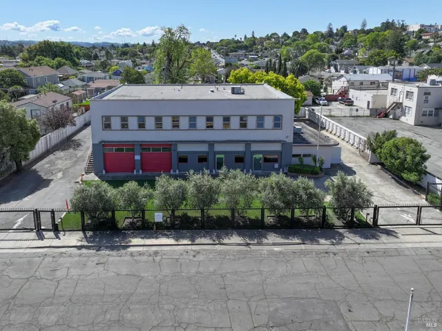 a view of house with yard and sitting area