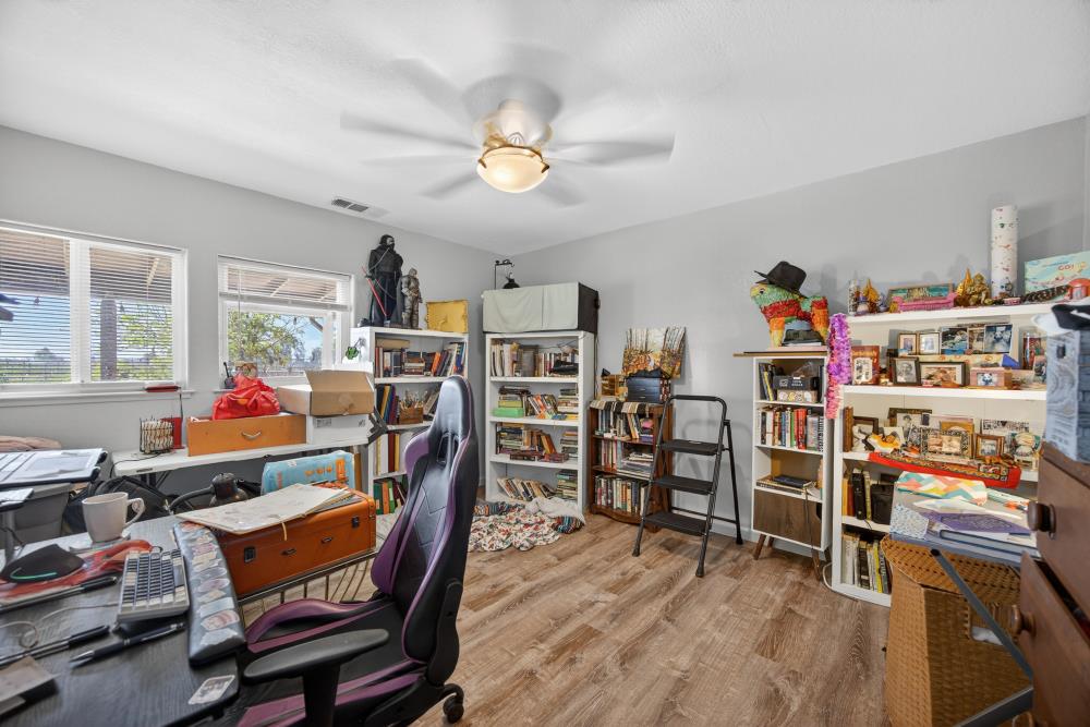 13512 Alta Mesa Road Galt, CA 95632 - Photo 45 of 99 a room with furniture a chandelier and a flat screen tv