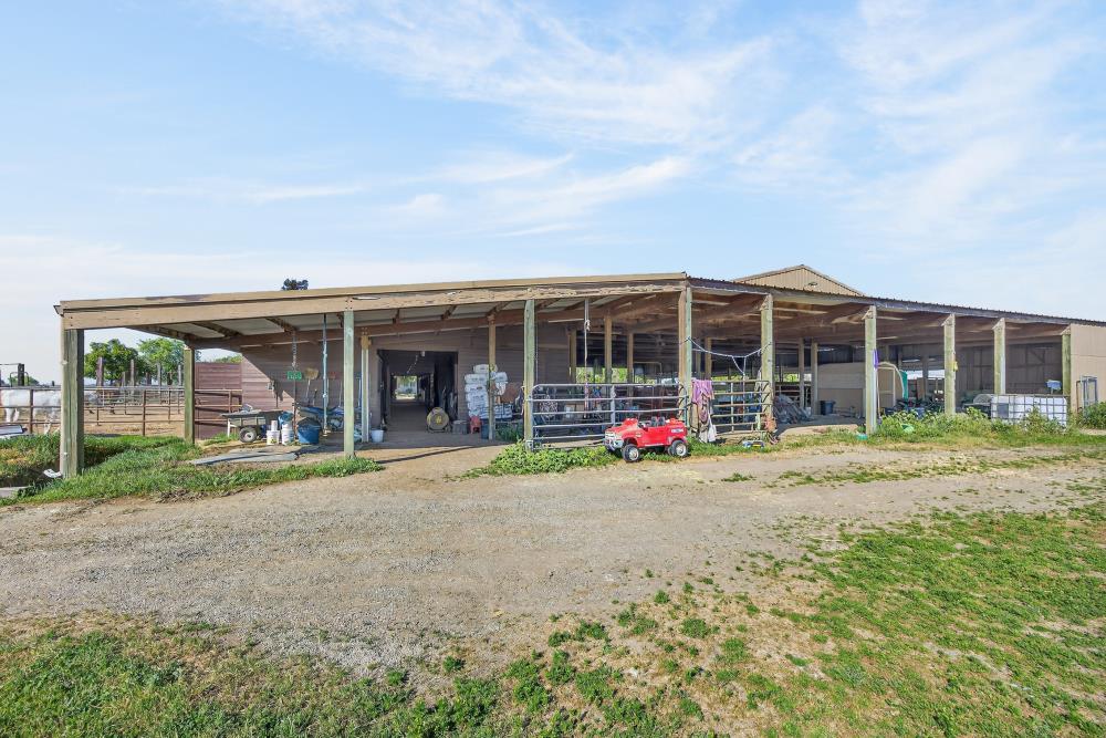 13512 Alta Mesa Road Galt, CA 95632 - Photo 68 of 99 a view of a house with a backyard and a porch