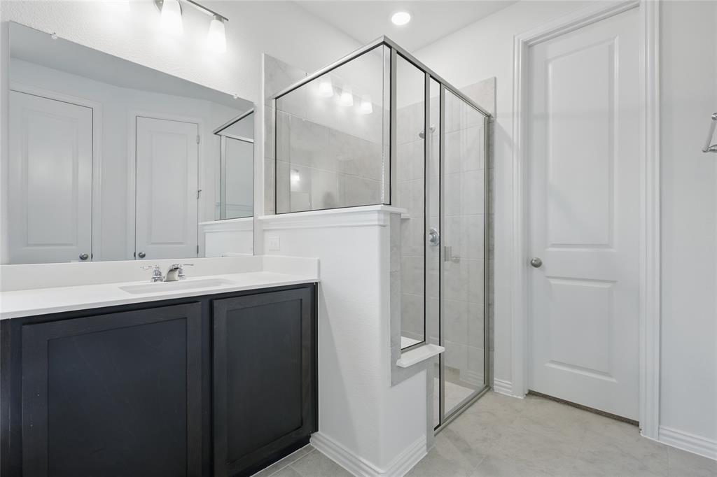 2521 Rivers West Road Anna, TX 75409 - Photo 18 of 40 a bathroom with a double vanity sink and mirror