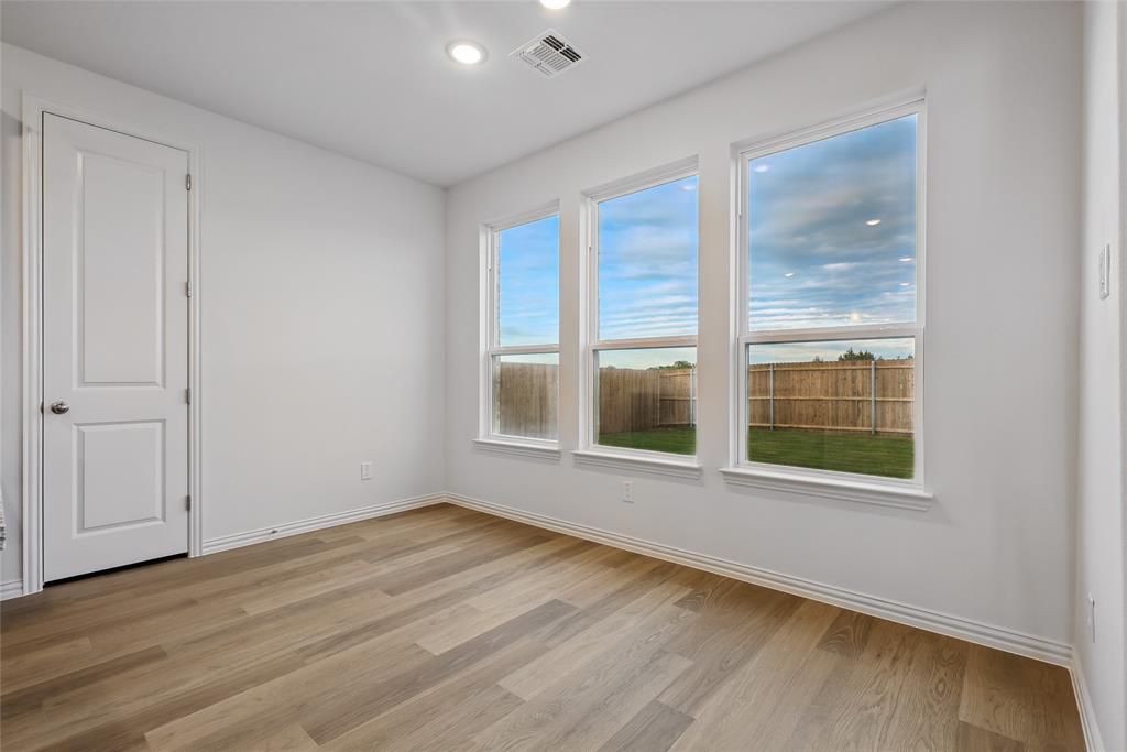 2521 Rivers West Road Anna, TX 75409 - Photo 9 of 40 a view of an empty room with wooden floor and a window