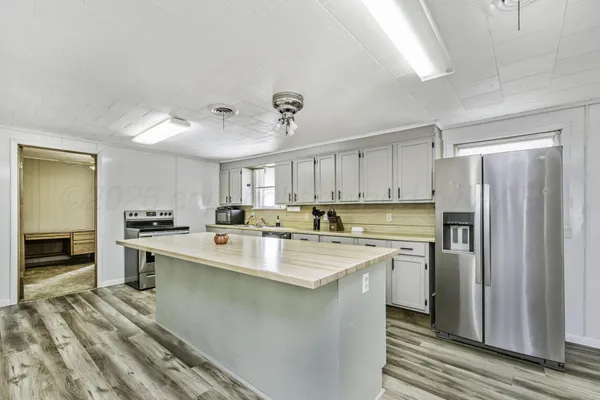 a kitchen with cabinets appliances and a counter space