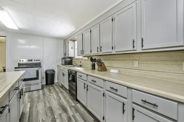 a kitchen with a sink stove and cabinets