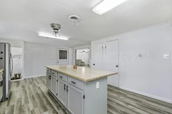 a view of a livingroom with a chandelier furniture and windows