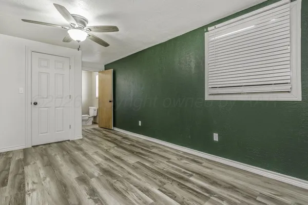 a bedroom with bed and a window