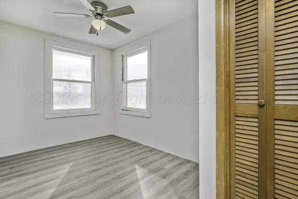 a view of room with ceiling fan and window