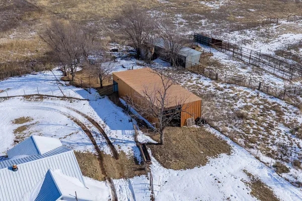 a view of yard covered with snow in front of house