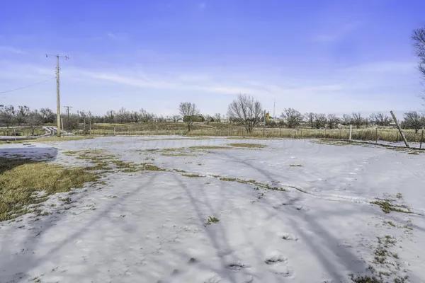 a front view of a house with a dirt yard