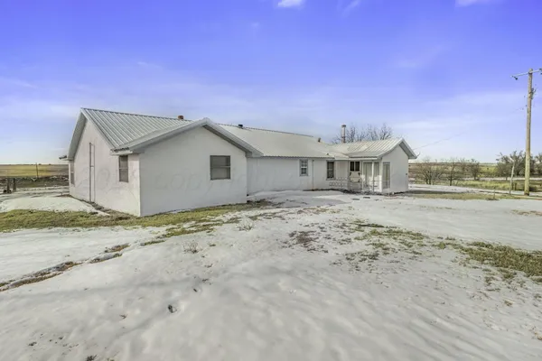 a view of a house with a snow in the yard