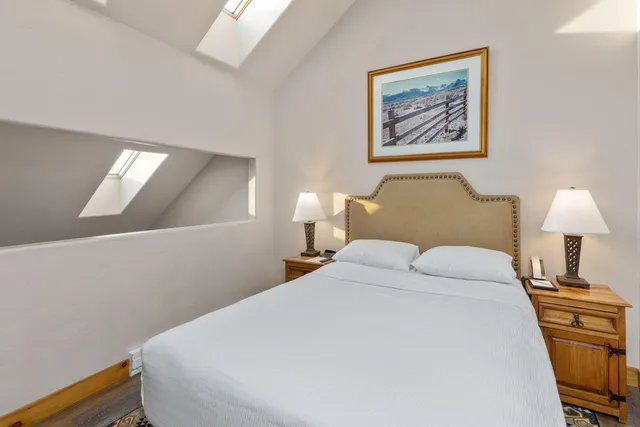 a bedroom with a bed and a lamp