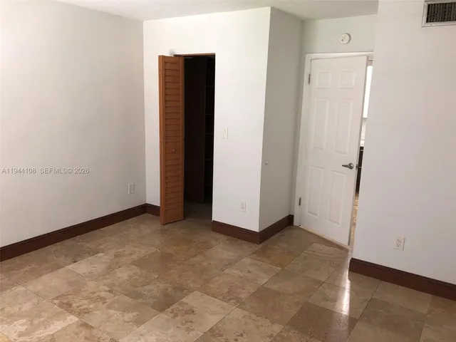 a kitchen with granite countertop a sink a stove and a refrigerator