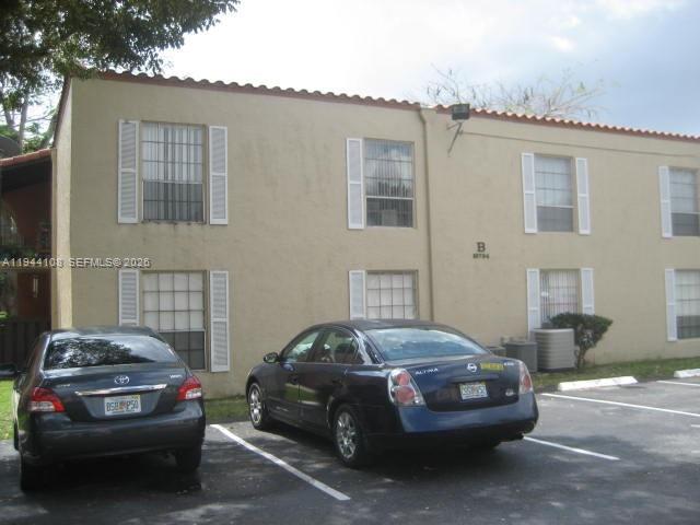 10794 North Kendall Drive, Unit B14 Miami, FL 33176 - Photo 19 of 23 a car parked in front of a house