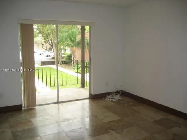 an empty room with sliding door and mountain view