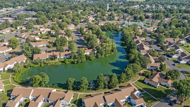 an aerial view of residential house with outdoor space and lake view