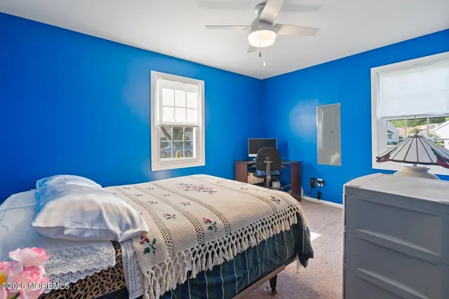 a bedroom with a bed and a mirror