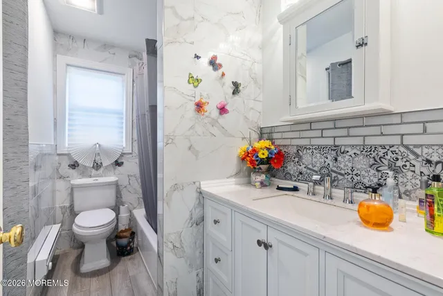 a bathroom with a sink a toilet and shower curtain