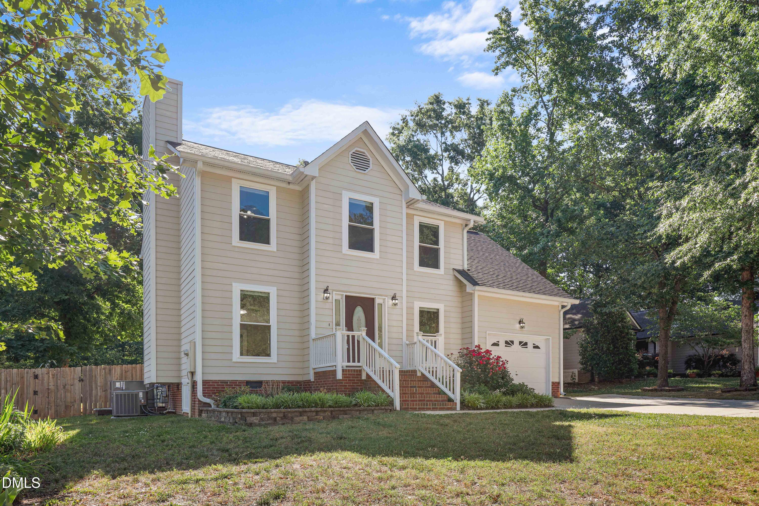 3015 Rennit Court Raleigh, NC 27603 - Photo 2 of 40 a view of a white house next to a yard with wooden fence