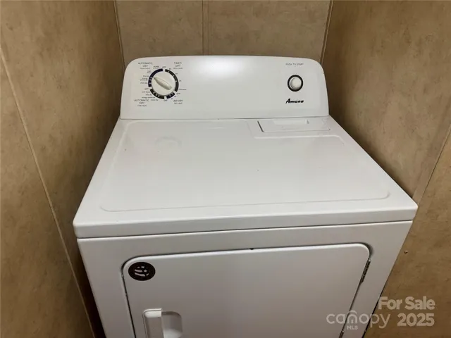 a kitchen with a sink a refrigerator and wooden cabinets