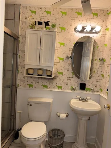 a bathroom with a sink toilet and mirror
