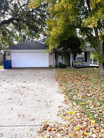 front view of a house with a tree