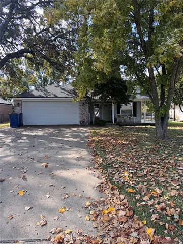 a view of a house with a large tree