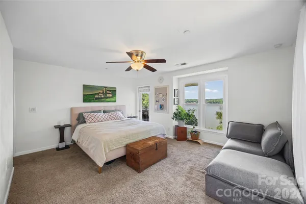 a bedroom with a bed and a couch