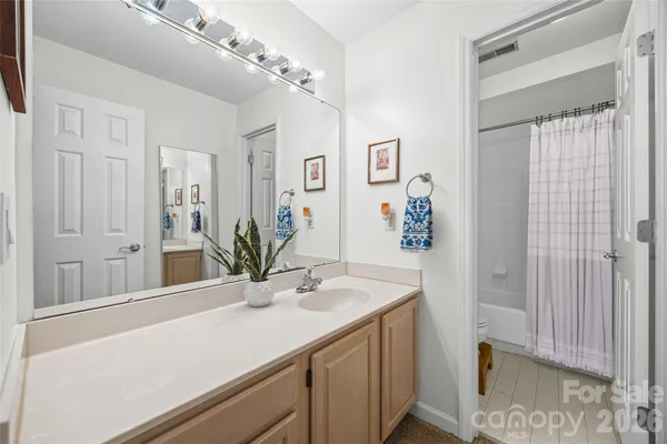 a bathroom with a shower curtain and a toilet