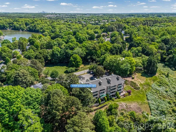 an aerial view of a house with a garden and lake view